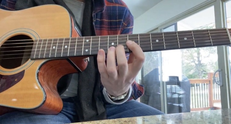 Somebody playing an acoustic guitar